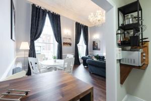 a living room with a blue couch and a table at 4 Poster Luxury Georgian Apartment in Dublin