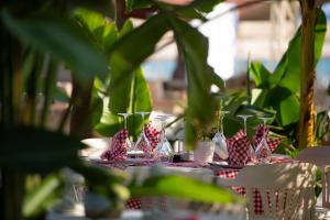 a table with red and white napkins and glasses on it at Miramare Beach Hotel - Ultra All Inclusive in Side