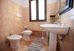 a bathroom with a sink and a toilet at Bella Vista 3 in Lu Lioni