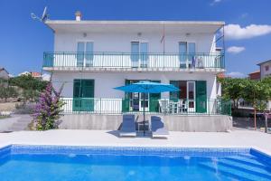 a villa with a swimming pool and a house at NEW! Apartments with shared pool, Vodice in Vodice