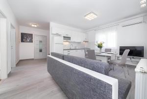 a living room with a couch and a dining room at NEW! Apartments with shared pool, Vodice in Vodice
