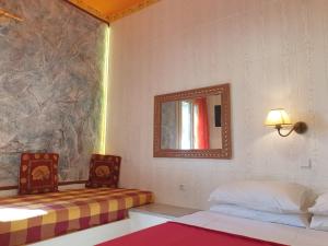 a room with two beds and a mirror at Place to stay for up to 10 vacationers in Hersonissos