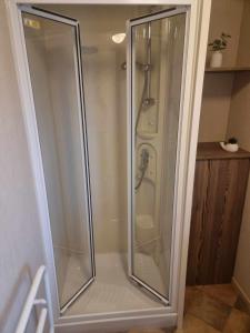a shower with glass doors in a bathroom at Lovely 3 Bed Caravan near to beach 5 star Reviews in Cleethorpes