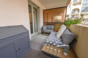 a small balcony with a couch and a window at Les Terrasses Montfleury, aux portes d'Annecy- Une exclusivité LLA Selections by Location lac Annecy in Annecy