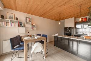 a kitchen and dining room with a table and chairs at Les Terrasses Montfleury, aux portes d'Annecy- Une exclusivité LLA Selections by Location lac Annecy in Annecy