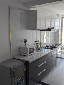 a kitchen with a microwave on a counter top at Hosted by Pauline in Nairobi