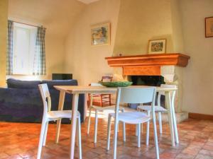 einen Tisch und Stühle im Wohnzimmer mit Kamin in der Unterkunft Gîte Cheillé, 3 pièces, 4 personnes - FR-1-381-68 in Cheillé