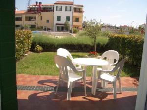 a white table and chairs sitting on a patio at Residence Garbin - Agenzia Cocal in Caorle