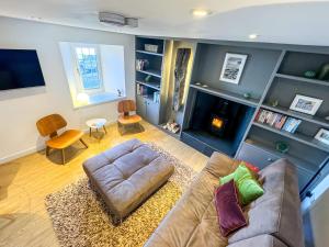 a living room with a couch and a fireplace at Studio House in St Margaret's Hope