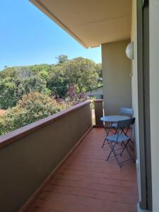 a balcony with a table and chairs on it at Residence San Francesco in Tirrenia