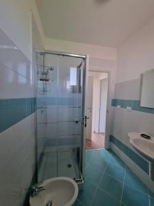 a bathroom with a shower and a toilet and a sink at Residence San Francesco in Tirrenia