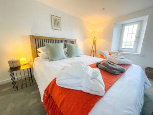 a bedroom with two beds with towels on them at Studio House in St Margaret's Hope