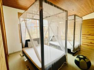 a bedroom with a canopy bed with a soccer ball at JP Hostels & Apartment in Kandy