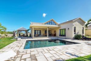 a house with a swimming pool in a yard at West Coast Villas in Tamarin