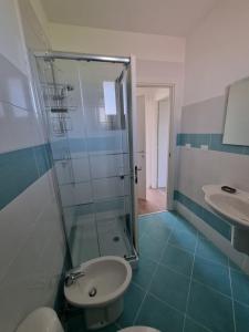 a bathroom with a shower and a toilet and a sink at Residence San Francesco in Tirrenia