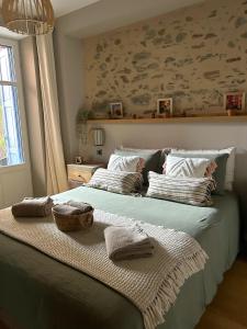 a bedroom with a bed with towels on it at «La Calade » Villa les Glycines in Collioure