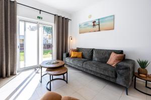 ein Wohnzimmer mit einem Sofa und einem Tisch in der Unterkunft Casa Serena, Portugal in Guia