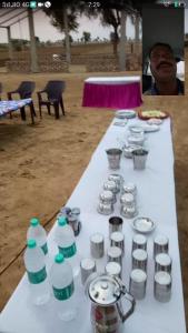 a table with cups and bottles of water on it at Royal Restaurants in Naorangdesar