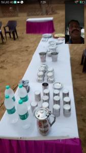 a table with a bunch of cups and bottles on it at Royal Restaurants in Naorangdesar