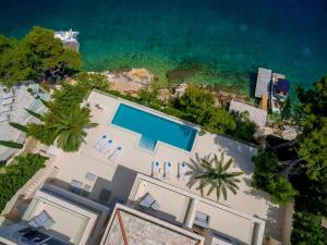 an overhead view of a house with a swimming pool next to the ocean at Villa Brac Neptuno - 6 Bedroom Luxury Villa - Sauna - Gym - Sea Views in Selca