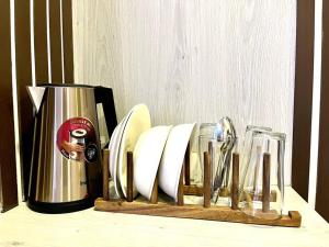 a counter with two glasses and a coffee maker at DiscoveryHome5 at Pratunammarket in Bangkok