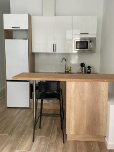 a kitchen with a wooden counter with a sink at Exyca Metropolitano in Madrid