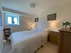 a bedroom with a large bed and a window at Swydd Long Barn Swyddffynnon in Ystrad-Meurig