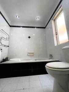 a bathroom with a toilet and a bath tub at Bay view Appartment in Paceville