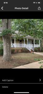 una foto de una casa blanca con un árbol en A place to stay worry free, en Greensboro