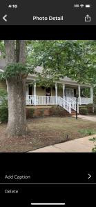 una foto de una casa blanca con un árbol en A place to stay worry free, en Greensboro