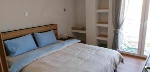 Ένα ή περισσότερα κρεβάτια σε δωμάτιο στο Foivos Apartment