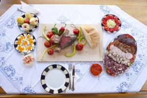 a table with plates of food on a table at Guest house Jurini Dvori in Kneževi Vinogradi