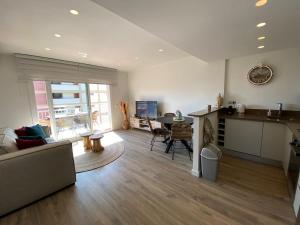 sala de estar con sofá, cocina y mesa en Perla del Mar, en Platja d'Aro 12 fotos más