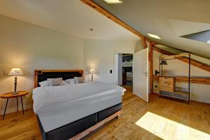 a bedroom with a large white bed in a room at Ferienwohnung Rupp in Sibratshofen