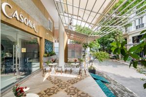 a building with tables and chairs and a glass ceiling at La Casona Boutique Hotel in Ho Chi Minh City