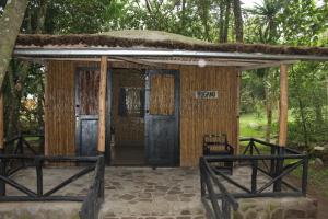 a small hut with a sign that reads retreat at Red Rocks Rwanda - Bamboo Cottage in Nyakinama