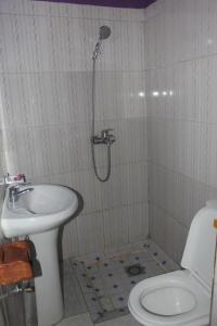 a bathroom with a shower and a sink and a toilet at Room in BB - Amahoro Guest House - Single Room with Shower in Ruhengeri
