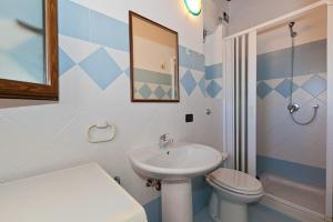 a bathroom with a sink and a toilet and a mirror at Terrazza delle mura in Cefalù