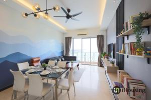 a dining room and living room with a table and chairs at Silverscape Deluxe Melaka by I Housing in Melaka