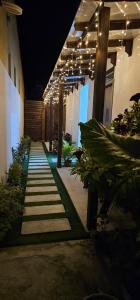 a hallway of a building with lights and plants at Blue Haven Retreat in Thulusdhoo