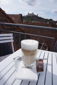 a cup of coffee sitting on a napkin on a table at City Apartement im Herzen der Stadt in Würzburg