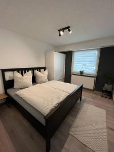 a bedroom with a large bed with white pillows at Ferienwohnung Wendel in Sankt Wendel