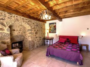 a bedroom with a bed and a fireplace at Gîte La Valla-sur-Rochefort, 5 pièces, 10 personnes - FR-1-496-44 in La Valla