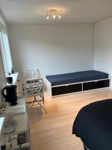 a bedroom with a bed and a chair in it at Private Room in Billund centre close to Lego House & Legoland in Billund