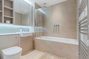 ein Badezimmer mit Dusche, Toilette und Waschbecken in der Unterkunft Elegant 2BR flat on 20th floor near many attractions in London + 31 Fotos