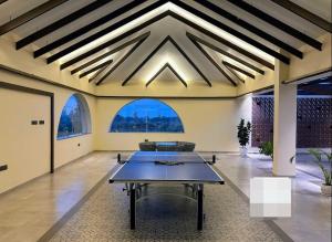 a living room with a table in the middle at Redhomex Cove Castle Villa in Hyderabad