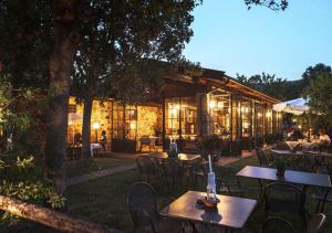 a restaurant with tables and chairs in front of a building at Tenuta Il Cicalino in Massa Marittima