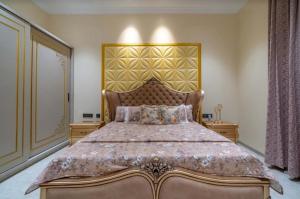a bedroom with a large bed and two night stands at Redhomex Cove Castle Villa in Hyderabad