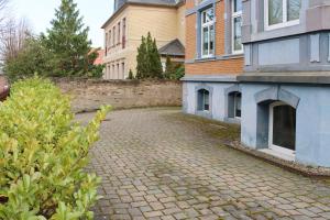 a brick driveway in front of a building at Ferienwohnung -Villa Am Stadtpark- Blankenburg mit Balkon und Sauna in Blankenburg