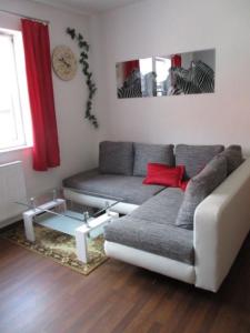 a living room with a couch and a table at Ferienwohnung Thüringer Wald in Ilmenau
